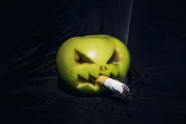 Concept of harm to health from Smoking. An evil Apple with cigarette in its mouth. — Stock Photo, Image