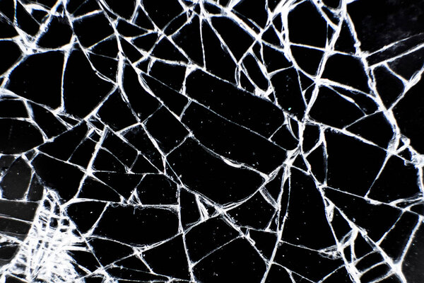 Broken glass tablet computer. Cracked screen. Cracks in the glass on black background.