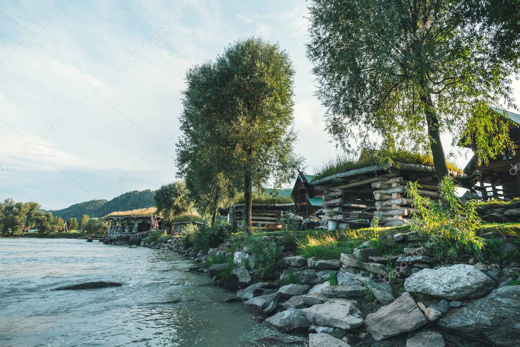 Small log houses for outdoor recreation are located on the river Bank. Hunting ground. Tourist base near the water.