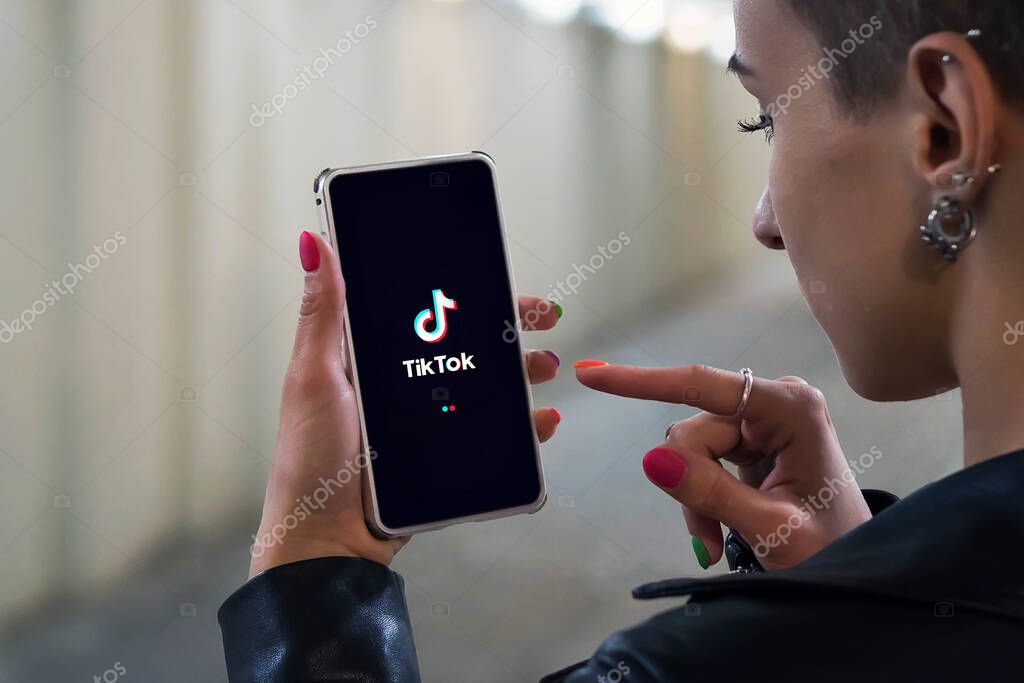 22.07.2018. Barnaul. Russia. Women holding Phone with TikTok logo on the screen. Tik Tok is Chinese app to create and share videos