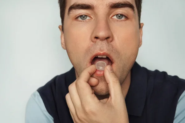 Young Cute Man Sucks Pill Inflammation Tonsils Man Eating Pills — Stock Photo, Image