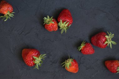 siyah arka plan üzerine çilek. Çilek kopya alanı ile koyu kara tahta üzerinde. Üstten görünüm noktası.