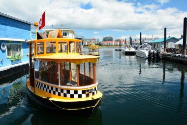 Victoria BC,Canada,July 12th 2020.A 30 year tradition of water ferries and taxis moving people around the inner harbor in Victoria.Come to Victoria and ride one yourself. clipart