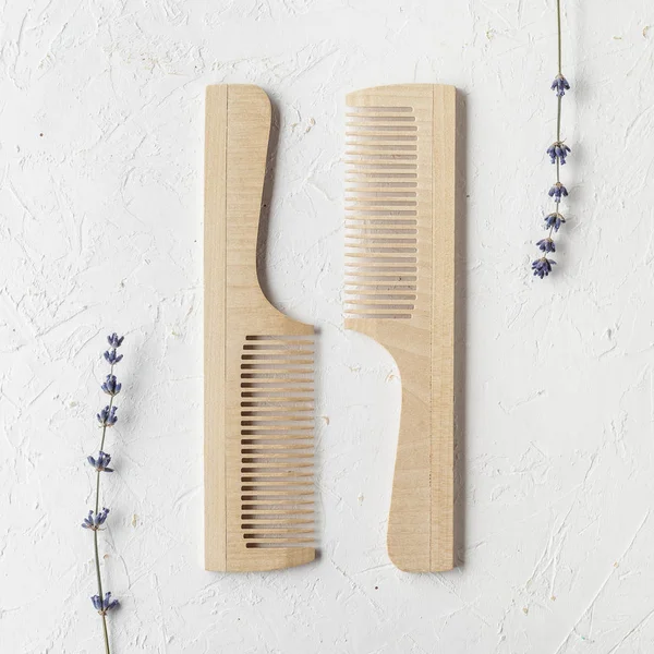 Wooden hair or beard combs flat lay on textured white background