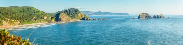 Scenic panoramic view of the Oregon coast and Three Arch Rocks National Wildlife Refuge at daytime, Tillamook County, Oregon state, West coast, USA