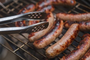 Barbekü ızgarasında ızgara sosis.