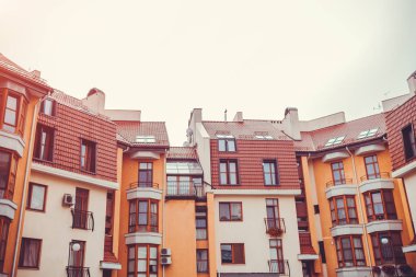 Yeni çok katlı konut binası. Modern ev kırmızı ve turuncu renklerde yağmurlu günde boyalı..