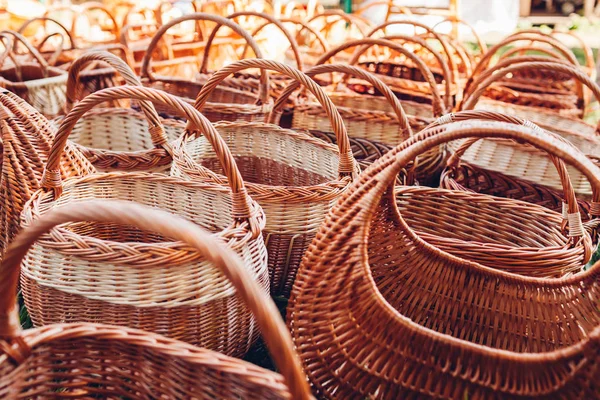 Straw baskets on sale in outdoor store. Wicker ukrainian bags on showcase of shop on national fair