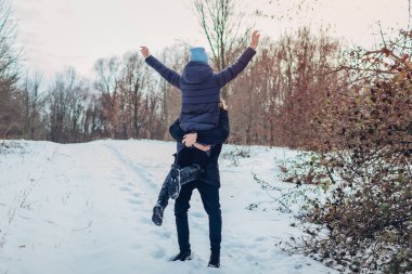 Holding ve kış ormandaki elinde onun kız arkadaşı kaldırma adam. Kız silah yükseltmek. Mutlu insanlar dışarıda eğleniyor