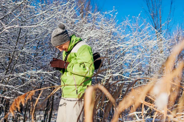 年轻的摄影师用相机检查冬季森林的照片 年轻男子拍摄风景照片户外 — 图库照片