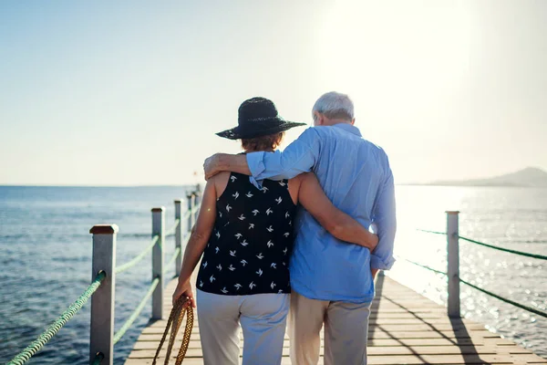 Senior couple walking on pier by Red sea in Egypt. People enjoying vacation. Valentine\'s day concept