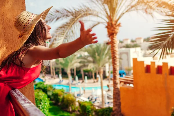 Genç kadının Mısır'daki otel balkon manzarası. Tropikal tatil açılan silah ile ücretsiz duygu mutlu turizm