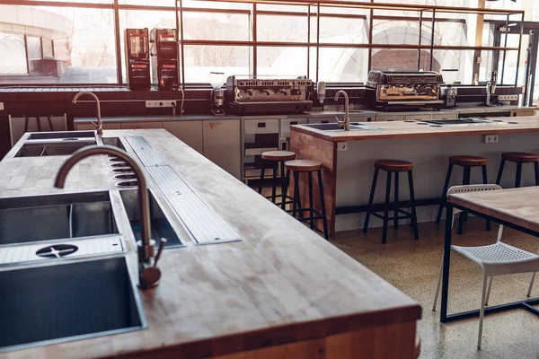 Water tap. Professional kitchen of restaurant. Modern equipment and devices. Empty kitchen in the morning.