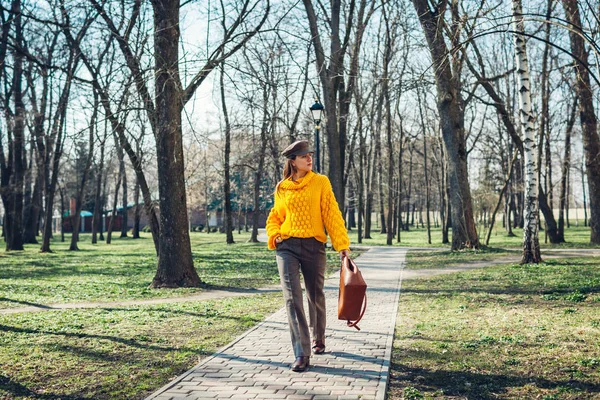 Young woman holding stylish handbag and wearing yellow sweater. Spring female clothes and accessories. Fashion — Stock Photo, Image