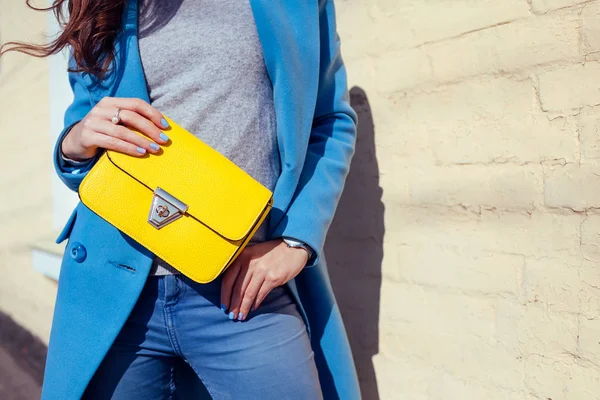 Young woman holding stylish handbag and wearing trendy blue coat. Spring female clothes and accessories. Fashion — Stock Photo, Image