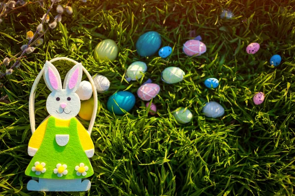 Happy Easter. Easter eggs hidden in spring grass. Basket bunny shaped. Holiday decoration — ストック写真