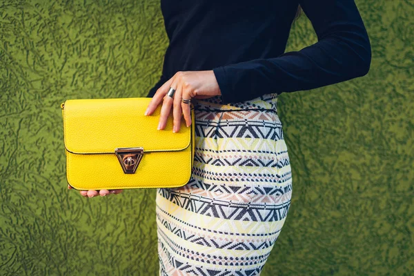 Young woman holding stylish yellow handbag. Spring female clothes and accessories. Fashion — Stock Photo, Image