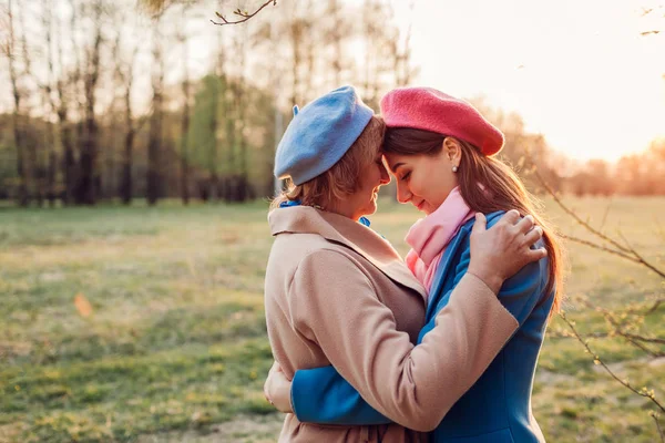 Senior mother and her adult daughter hugging in spring forest. Mother's day concept. Family values — Stock Photo, Image