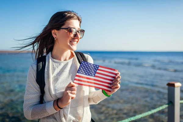 年轻的女游客欣赏红海的风景，并在码头上挂着乌萨旗。 美国独立日 — 图库照片