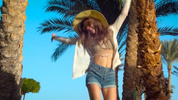 Happy Young Woman Jumping Playing Hat Having Fun Palm Trees — Stock Video