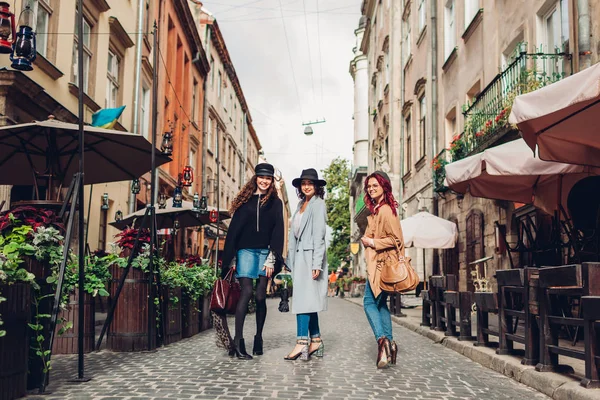 Дівчата розмовляють і розважаються. Відкритий знімок трьох молодих жінок, що ходять по міській вулиці . — стокове фото