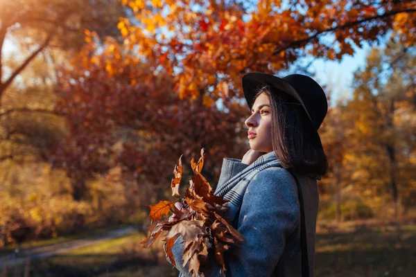 Actividades de otoño. Mujer joven caminando en el parque de otoño con ropa elegante y accesorios . —  Fotos de Stock