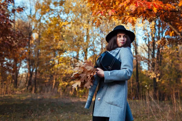 공원을 여자가 나뭇잎으로 지갑을 있습니다 의복과 액세서리 — 스톡 사진