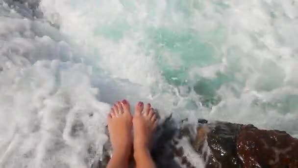 Die Meereswelle Bedeckt Weibliche Beine Auf Felsen Mit Einem Spritzer — Stockvideo