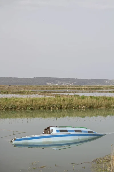 On the Slovenian cycle path of the Parenzana railway from Portoroz to the Croatian border - countless colorful fishing and sailing boats float idyllically on a canal