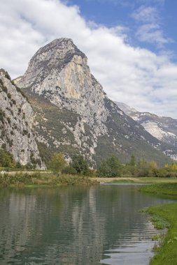 Çok kayalık zemin Piccolo Dain dağının önünde Sarca Nehri üzerinde sakin bir yer