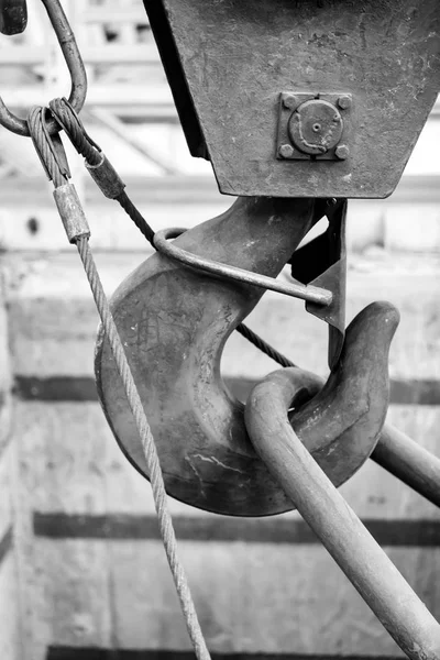 large iron hook used to lift heavy loads in a workshop with safety latch