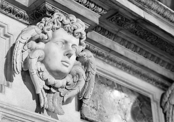 angel face inside the Milan cathedral, black and white photography