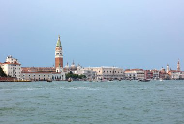 San Marcos square in Venice, seen from the sea with hundreds of tourist walking on the edge of the lagoon clipart