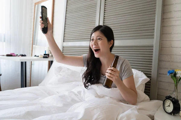 Asyalı kadın elleri elinde tutan ve havadaki televizyon onun favori basketbol takımı için tezahürat kadar zam.