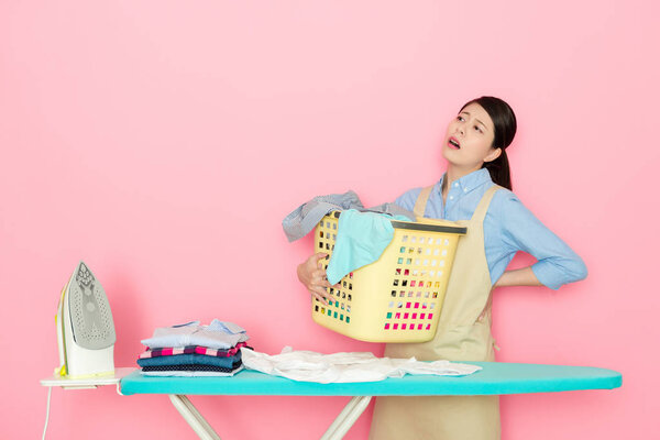 beautiful housewife feeling painful after too much housework and ironing.