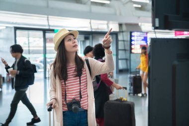 Uçus tarifesi, Asya kadın poniting. Onu uçuş aramak çalışıyor. 