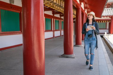 çekici kadın için hedef aracılığıyla tapınağın koridorda yürürken bir Kılavuzu harita ile arama.