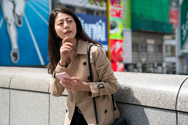 female traveler finding the right direction and looking at the map on the smartphone