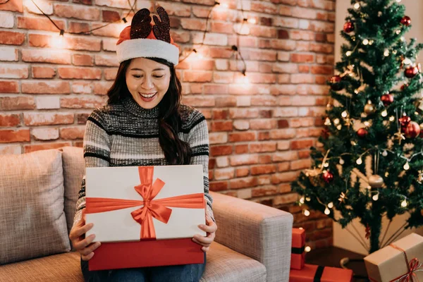 young girl open the gift box with a pleased face. shining diamond as present in the box shopping from christmas sale at boxing day. receive xmas gift concept.