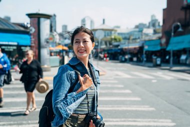 Bayan fotoğrafçı güneş sokak zebra crossing yürüyüş zevk rahatlatıcı. neşeyle yolda ayakta güneşli günde gülümseyen genç kız. bahar güzel Asyalı kadın seyahat ABD.