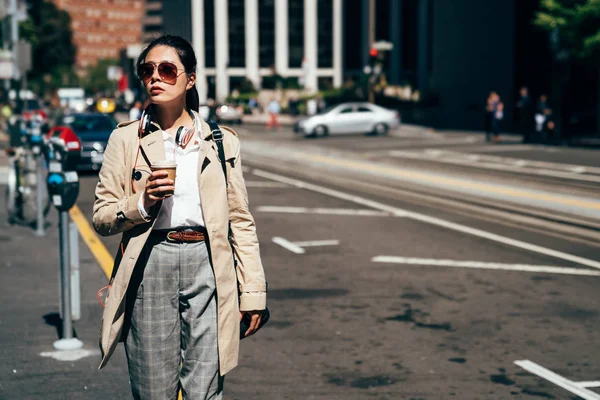 アジアの女性アウトドア ウォーキングストリートは日光の下でコーヒー カップを保持します サンフランシスコの朝仕事に行く若いオフィスレディ スマート カジュアルなスーツとサングラスを身に着けているエレガントな実業家 — ストック写真