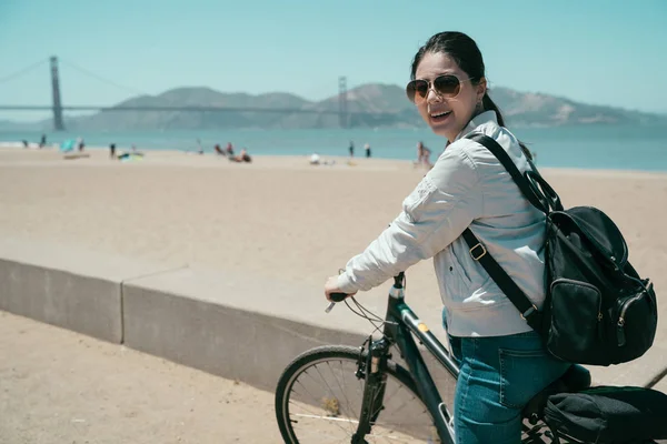 Female Tourist Face Camera Smiling Sunglasses Riding Bike Ocean Asian — Stock Photo, Image