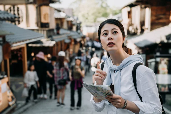 Asian Woman Tourist Holding Paper Map Pointing Direction Standing Sannen — Stock Photo, Image