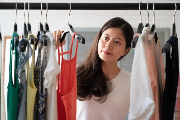 elegant smiling woman choosing clothes