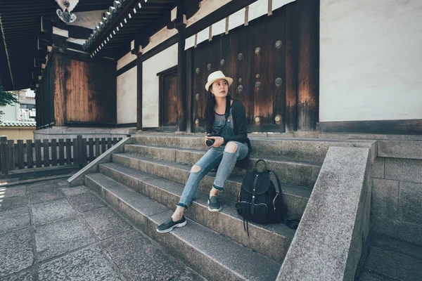 Smiling asian woman with hat taking pro camera — Stock Photo, Image