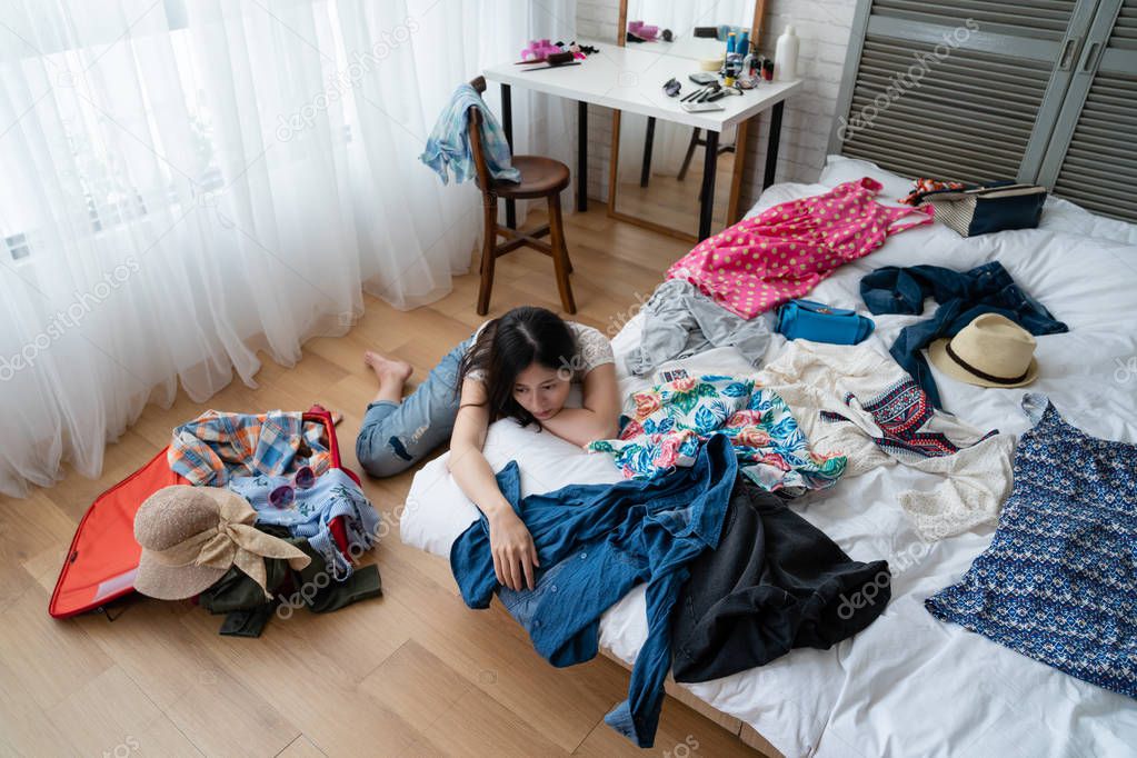 asian woman at home packing for luggage