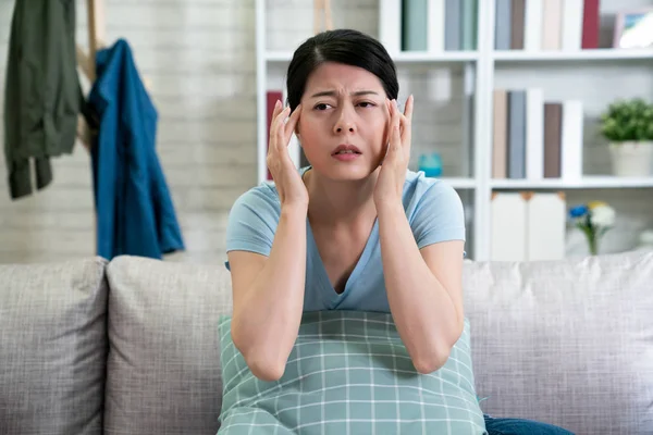 Жена дома показывает, как сильно болит голова — стоковое фото