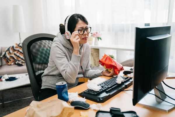 Asian Young Girl Friend Angry At Boyfriend Playing Online Game On Computer.  Mad Female Pushing Guy And Scolding At Him. Frowning Man Ignores His  Annoyed Lover And Wearing Headphones Keep Having Fun.