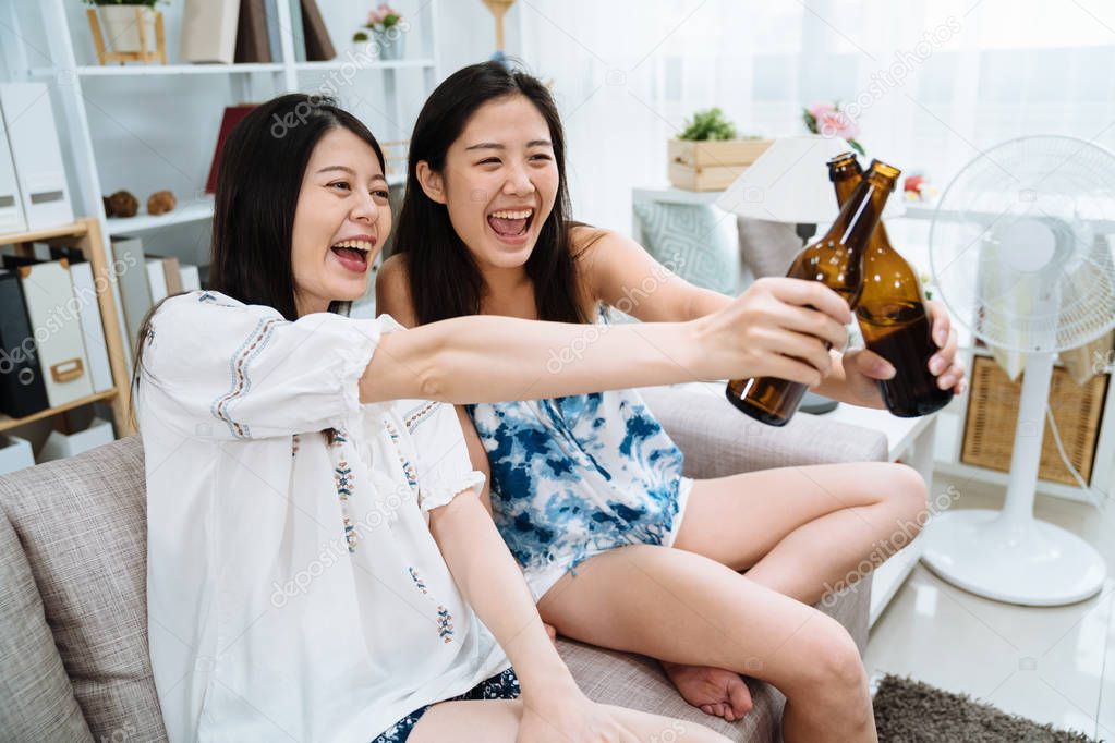 friends toasting drinking beer in living room