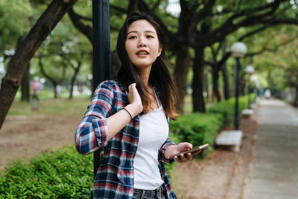 Woman touch soft hair hold smartphone — Stock Photo, Image